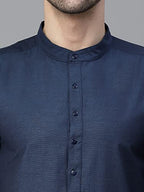 Solid Kurta With Mandarin Collar, Long, Regular Sleeves, Pathani Shape With Regular Style, Knee Length With Curved Hem. Pair It With White Churidar And Tan Mojri To Elevate The Look