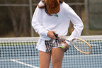 THE AGGIE BROWN PLAID SKORT— POLISHED PLAID FOR PLAY, PRACTICE, AND POST-MATCH PLANS.