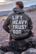 Lift Heavy. Trust God. - Premium Darkwood Camo Hoodie