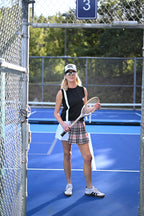 THE AGGIE BROWN PLAID SKORT— POLISHED PLAID FOR PLAY, PRACTICE, AND POST-MATCH PLANS.